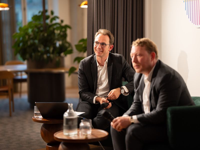 Two colleagues chatting in the office lounge